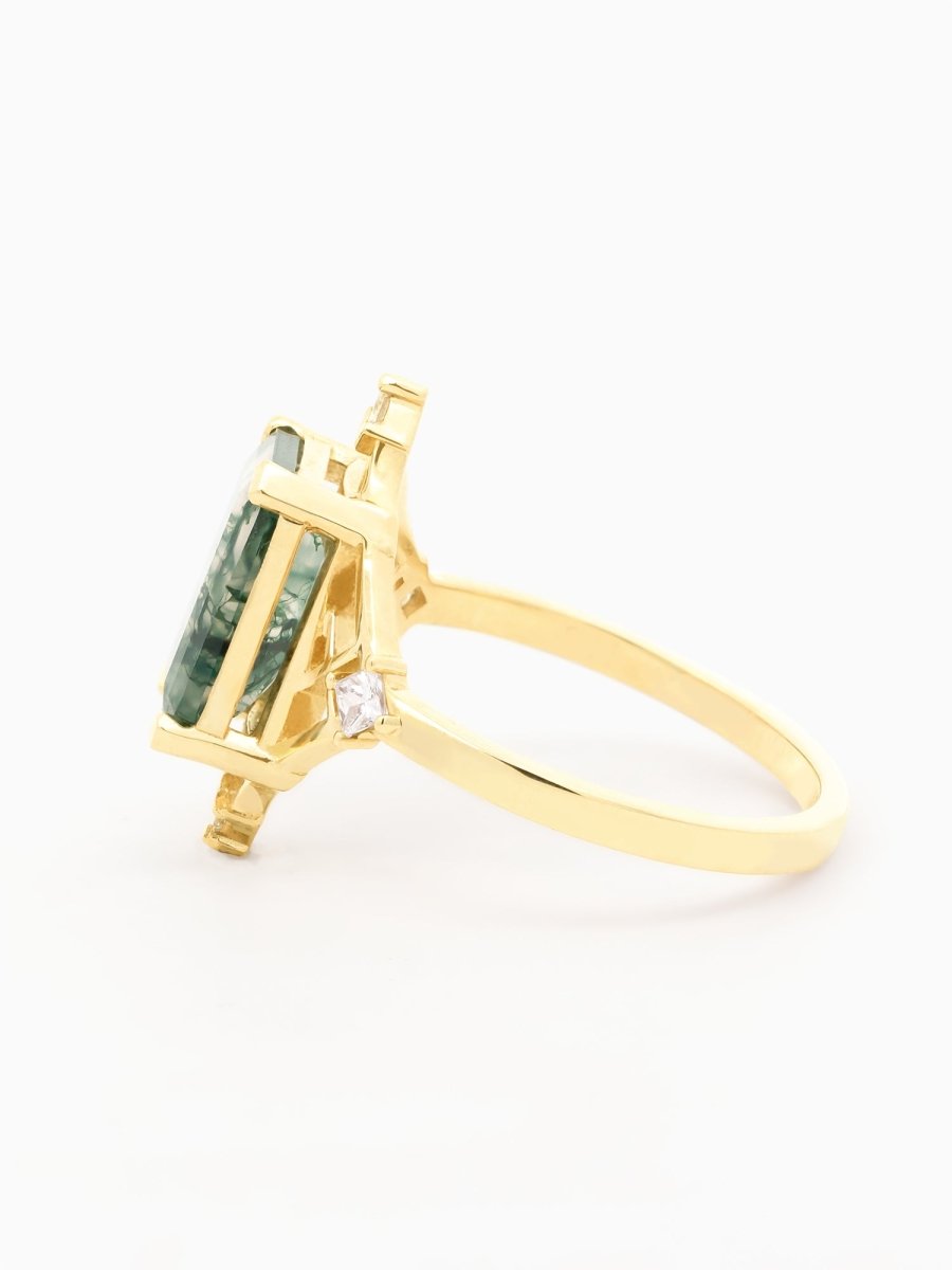 Side view of ring showing floating moss agate above open geometric gold setting