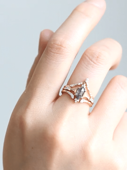 Minimalistic and art deco styled hexagon salt and pepper diamond engagement ring in 14k rose gold with round and baguette diamonds.