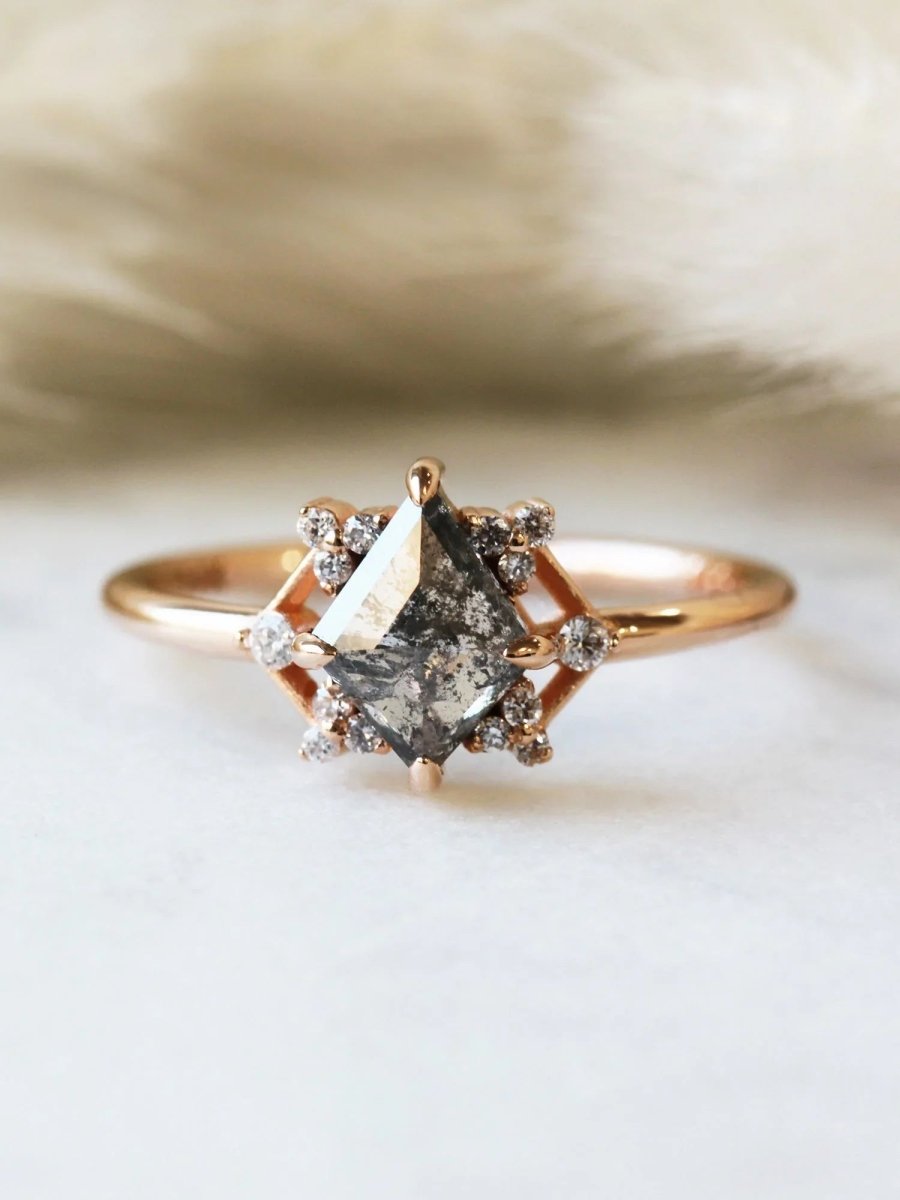 Delicate art deco style kite salt and pepper diamond engagement ring in 14k rose gold with smaller round diamonds.