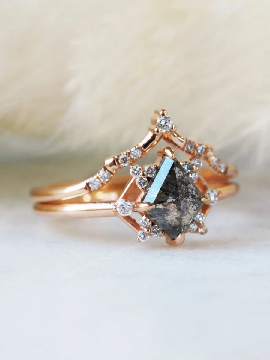 Delicate art deco style kite salt and pepper diamond engagement ring in 14k rose gold with smaller round diamonds.