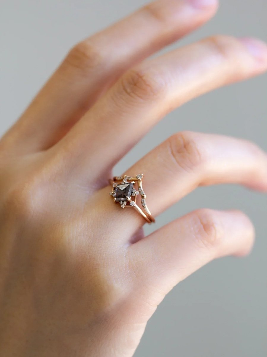 Delicate art deco style kite salt and pepper diamond engagement ring in 14k rose gold with smaller round diamonds.