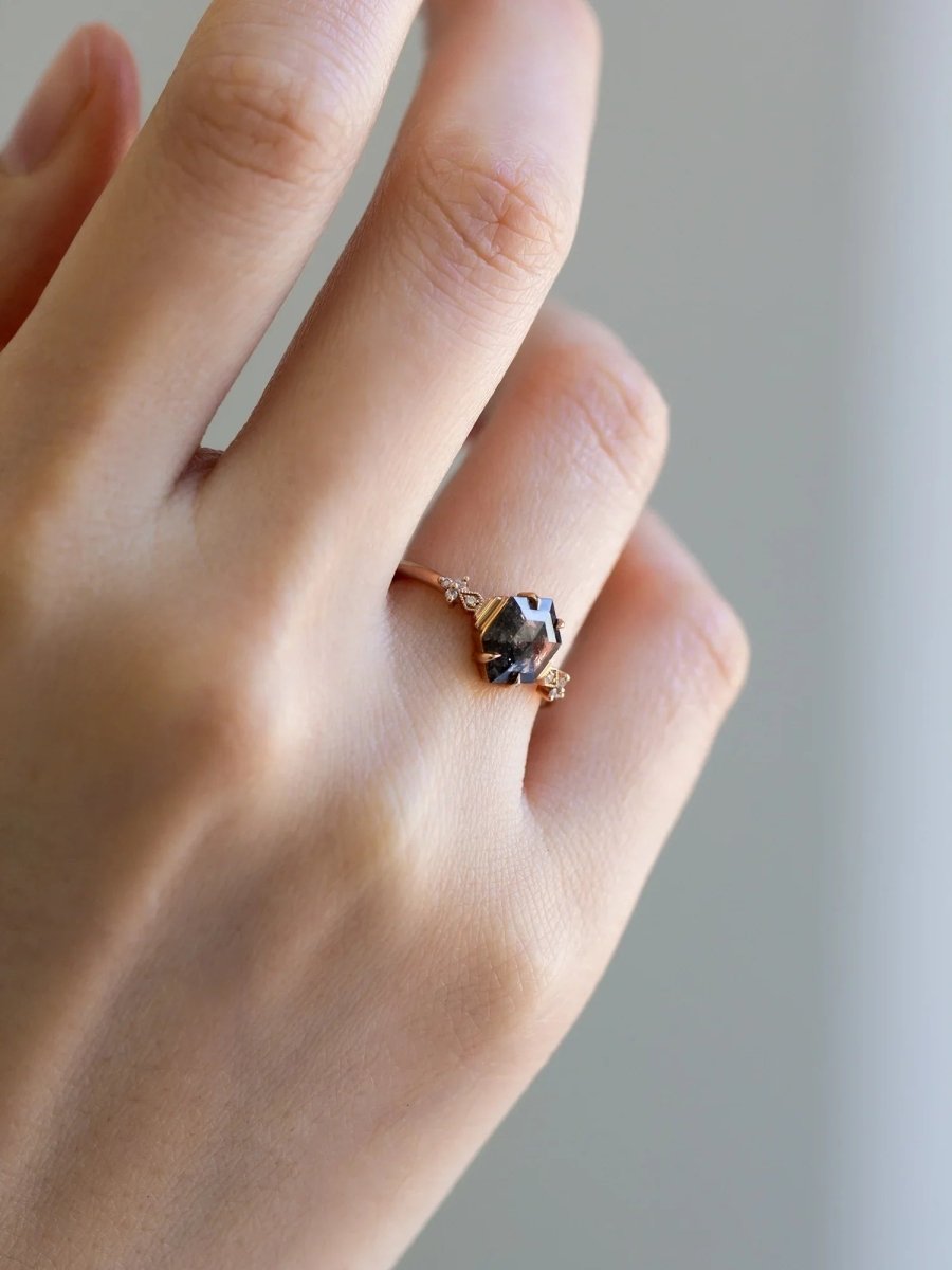Minimalistic and art deco styled hexagon salt and pepper diamond engagement ring in 14k rose gold with round diamonds.