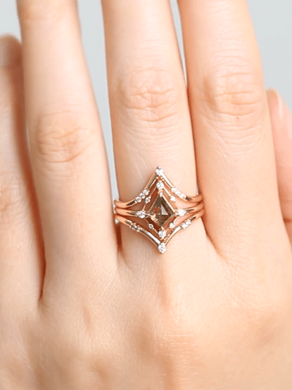 Minimal art deco styled kite shaped salt and pepper diamond engagement ring in 14k rose gold with smaller round diamonds.