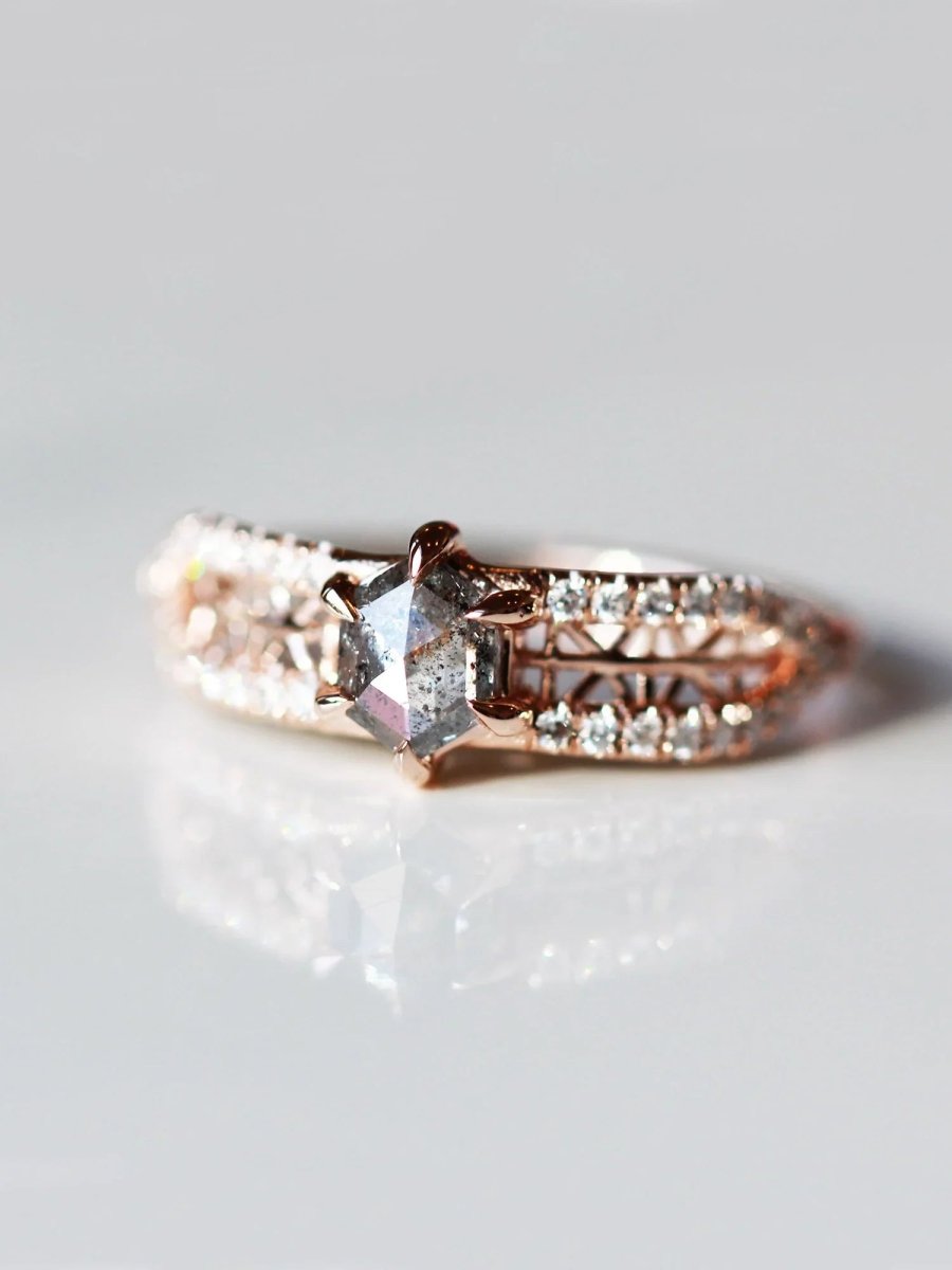 3/4 view of contemporary engagement ring in sunlight, showcasing the brilliance of the salt pepper diamond and sparkle of pave melee