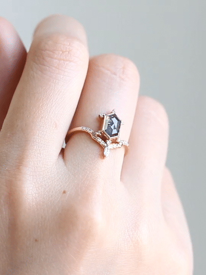 Unique art deco styled hexagon salt and pepper diamond engagement ring in 14k rose gold with a marquise and round diamonds.