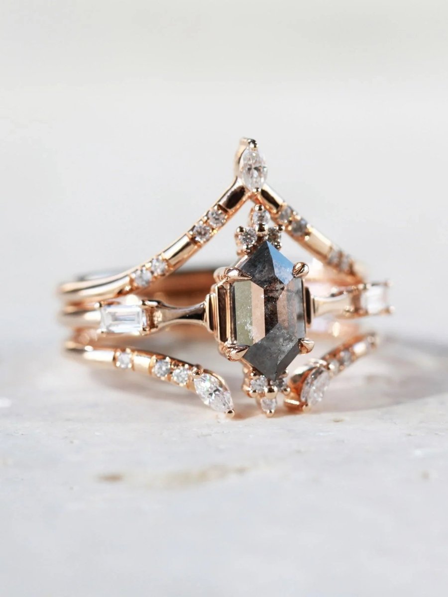Minimalistic and art deco styled hexagon salt and pepper diamond engagement ring in 14k rose gold with round and baguette diamonds with matching bands.