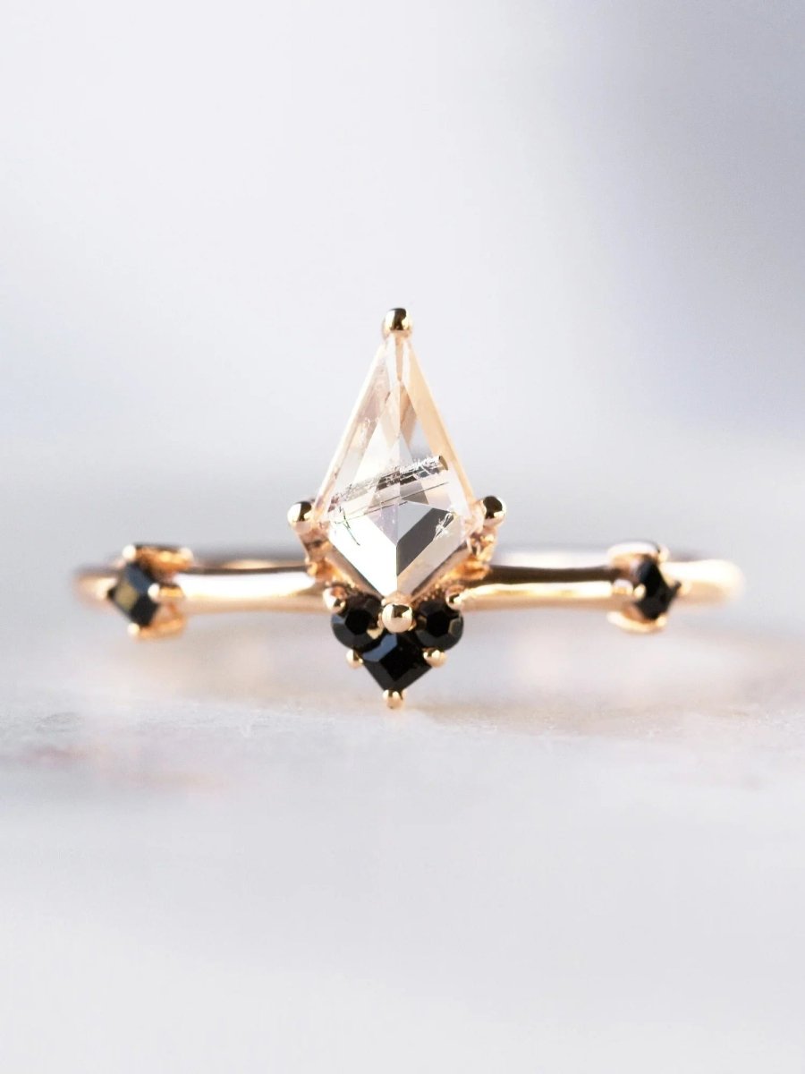 Face view of minimalist Art Deco ring in sunlight, showing kite tourmalinated center and onyx accents with natural sparkle