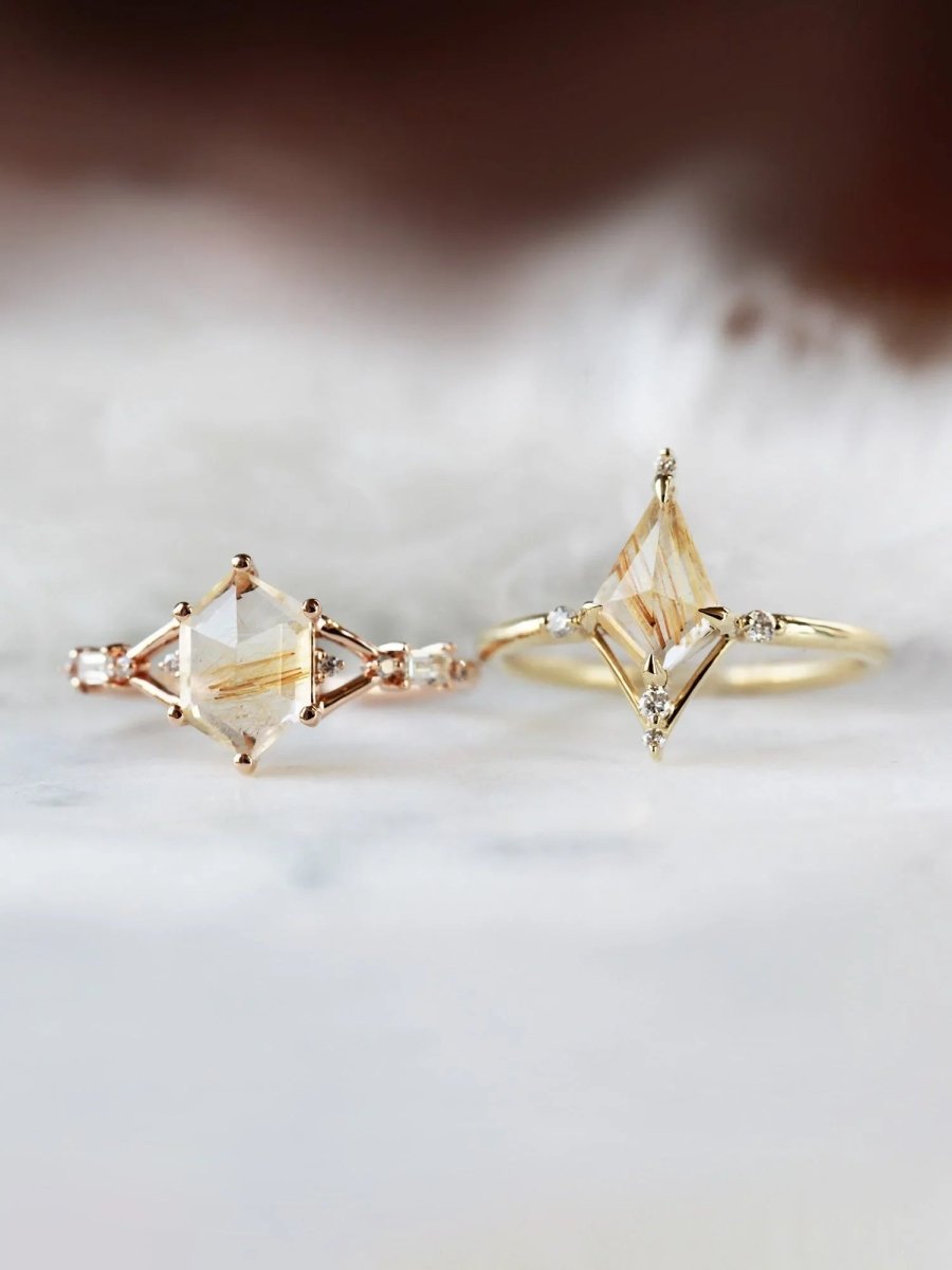 Hexagon rutilated quartz engagement ring in 14k rose gold with smaller baguette and round diamonds inspired by the art deco style and minimalism.