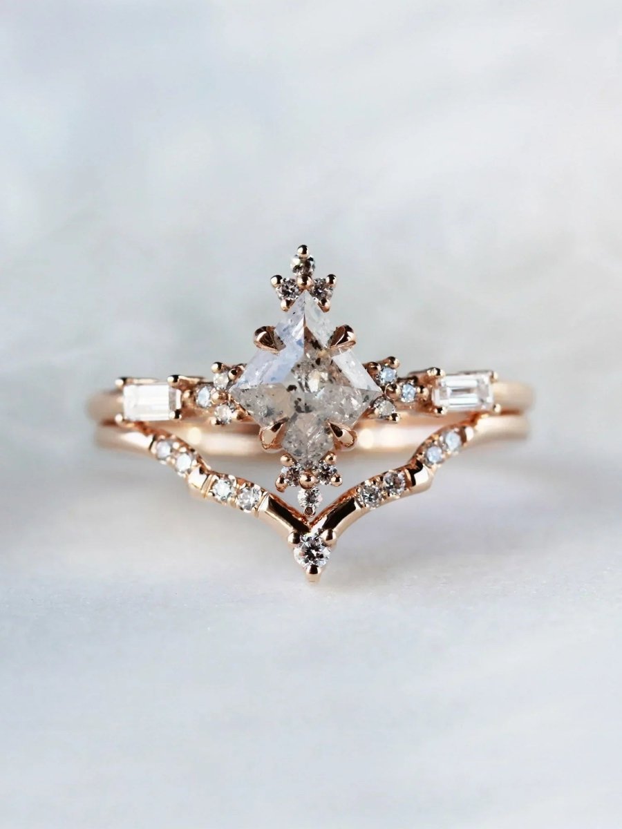 Rose gold ring with diamond accents on a light gray background