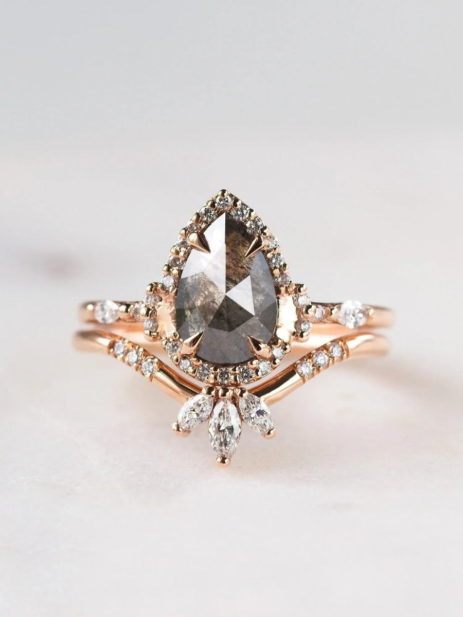 Pear-shaped salt and pepper diamond engagement ring in 14k rose gold with matching band inspired by the art deco style and minimalism.