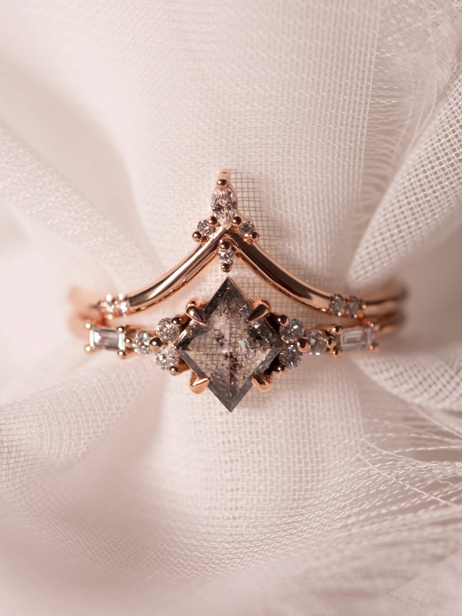 Petite ring with galaxy kite salt and pepper diamond and trefoil melee accents stacked with chevron band, on sheer fabric display.