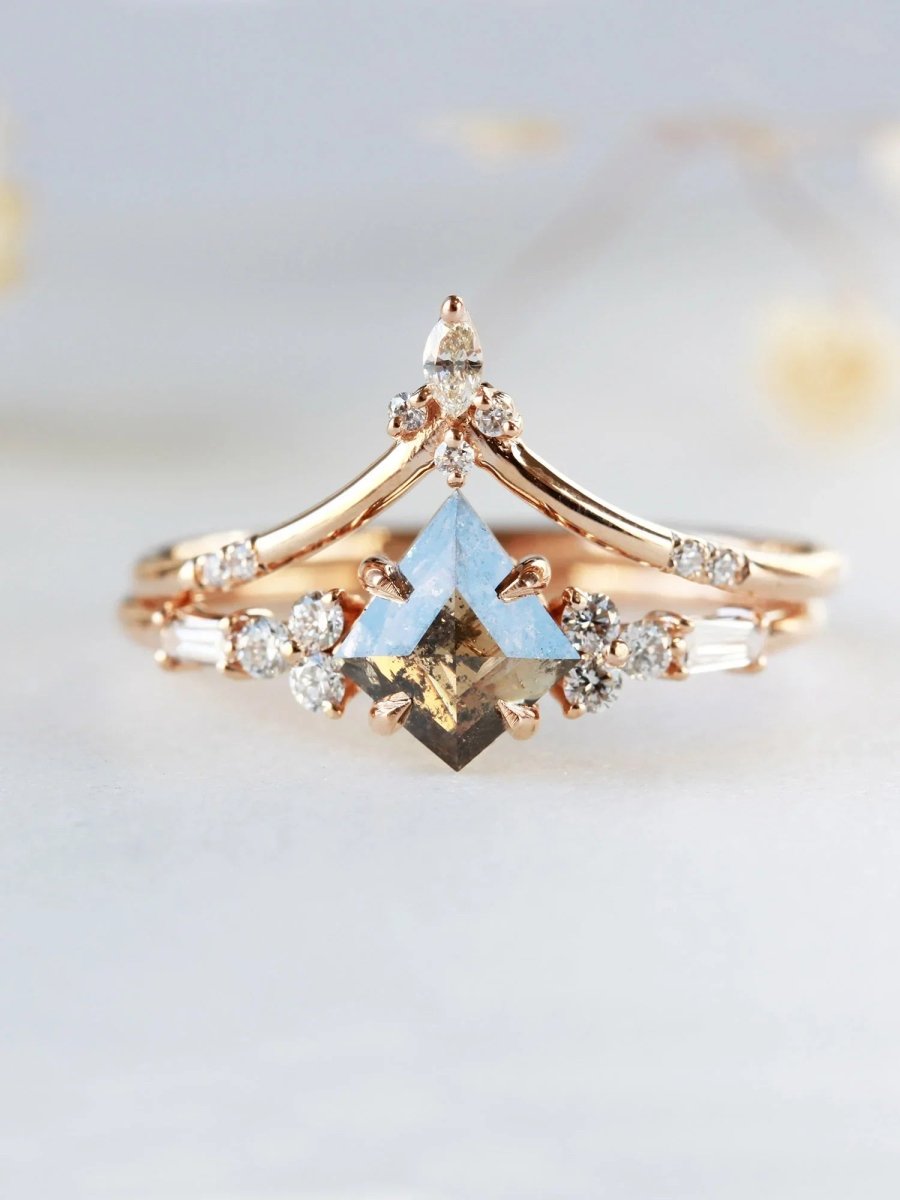 Face view of petite ring with gold kite salt and pepper diamond, trefoil melee accents on shoulders, with chevron band