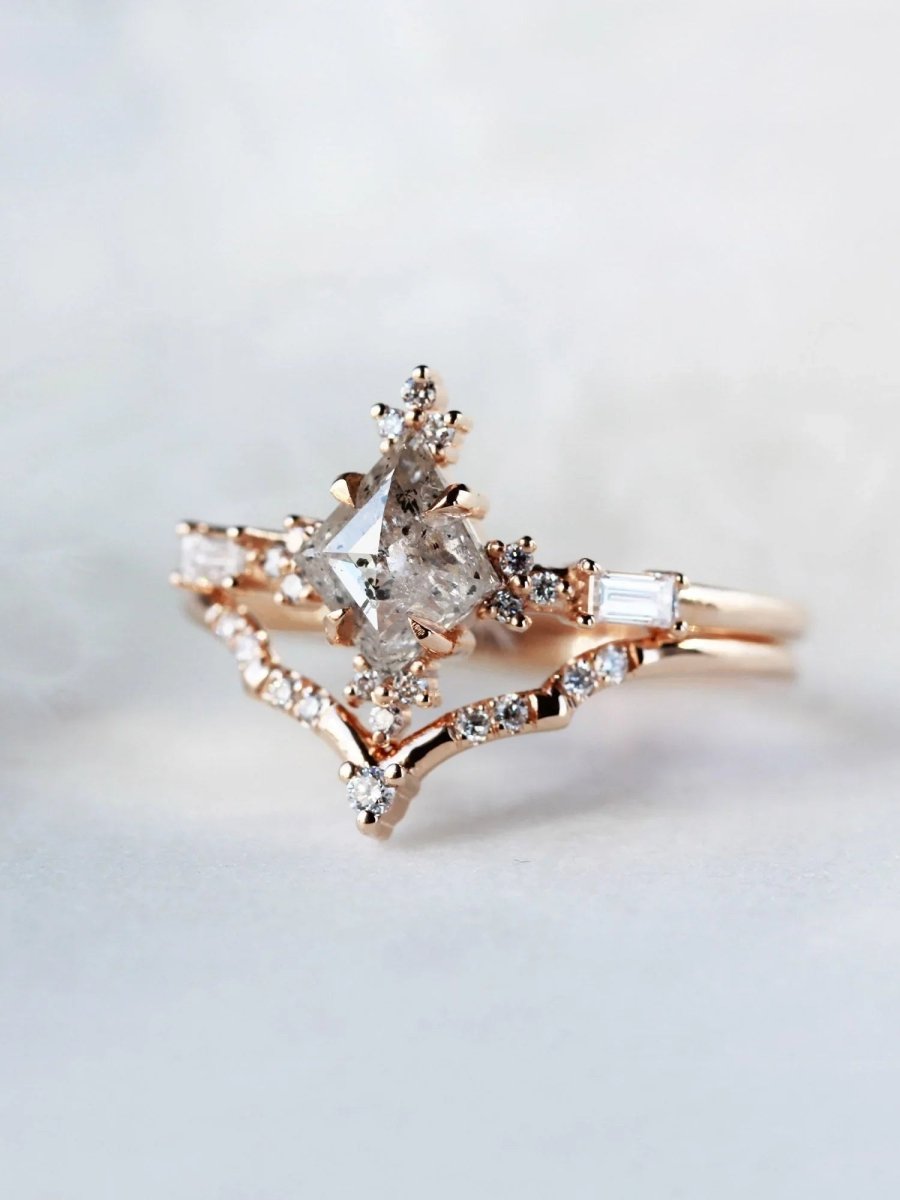 Rose gold ring with diamonds on a light gray background