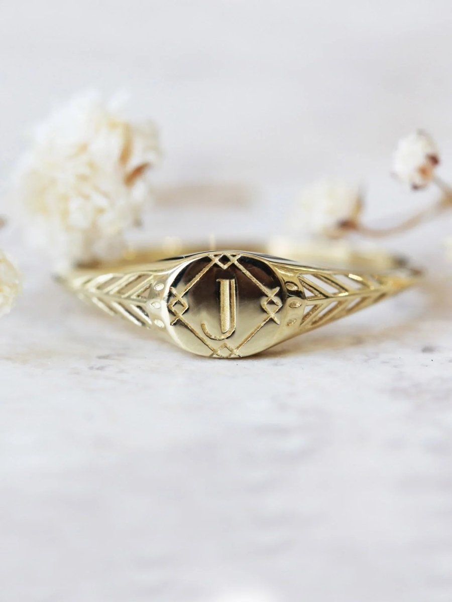 Gold bracelet with geometric design on a light background