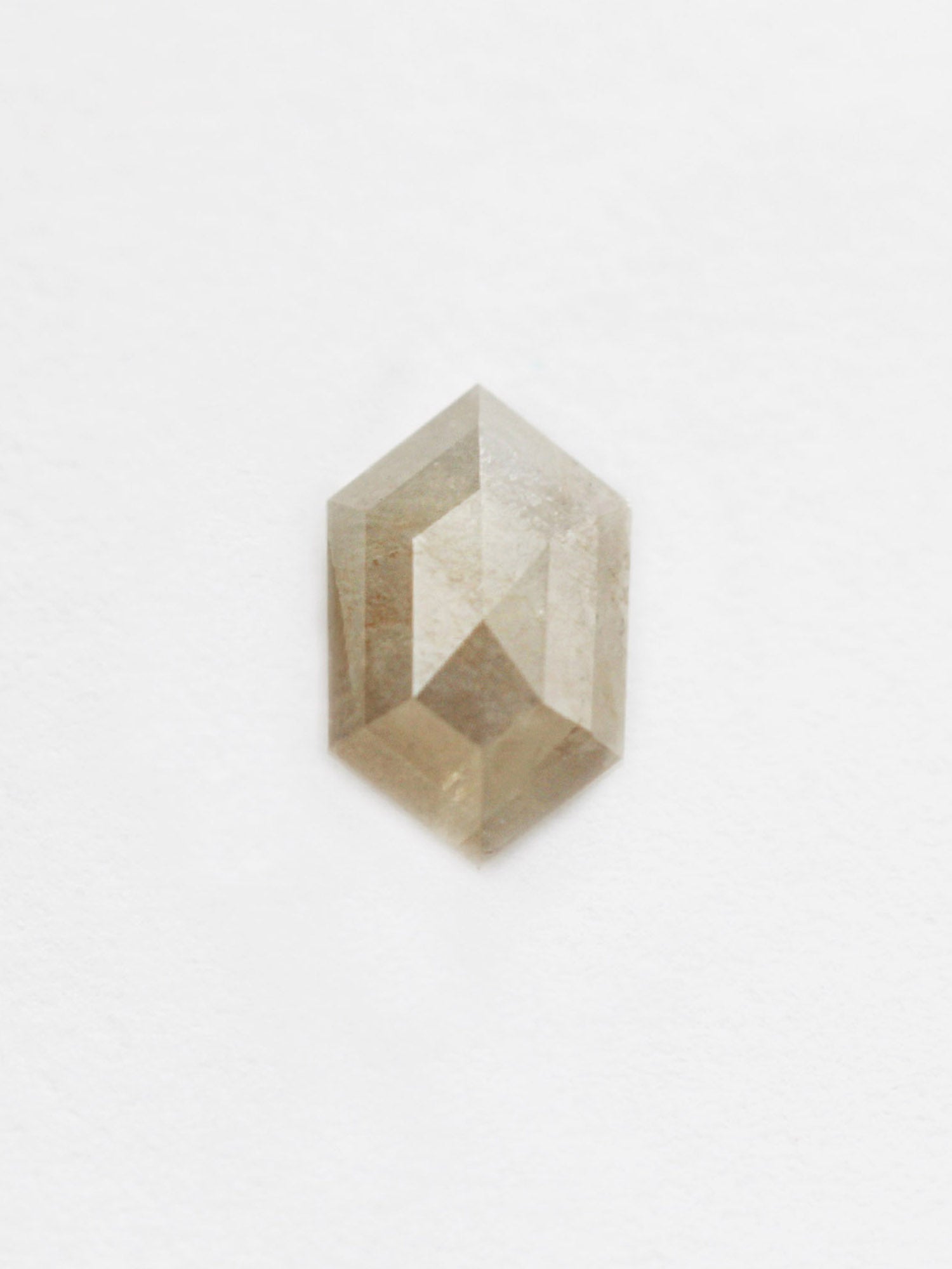 A 0.86CT salt and pepper hexagon-shaped diamond on a white background