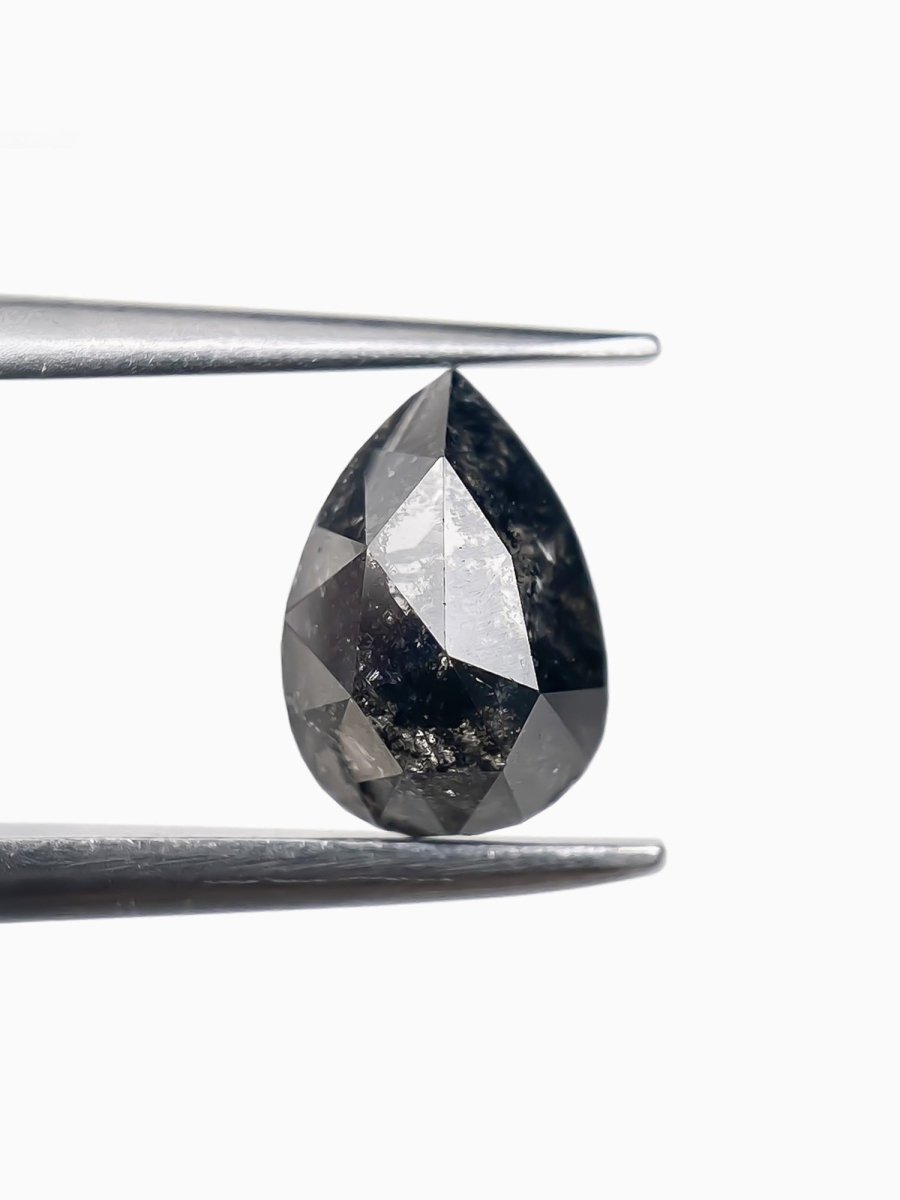 sustainable lab-grown pear shaped salt pepper diamond between tweezers