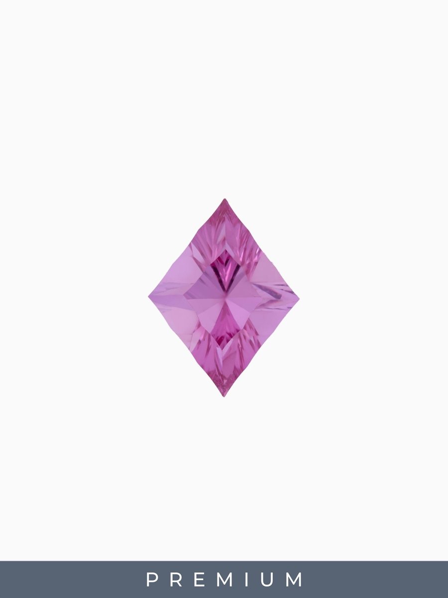 face view of designer cut burgundy kite sapphire on a white background with premium label