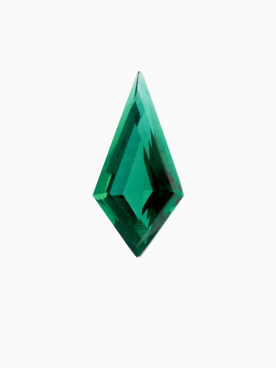A kite-shaped, green emerald gemstone