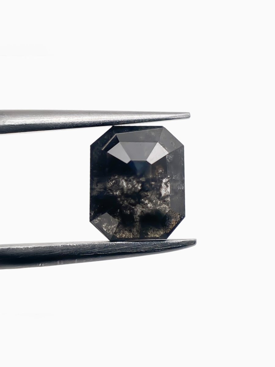 sustainable lab-grown emerald shaped salt pepper diamond between tweezers