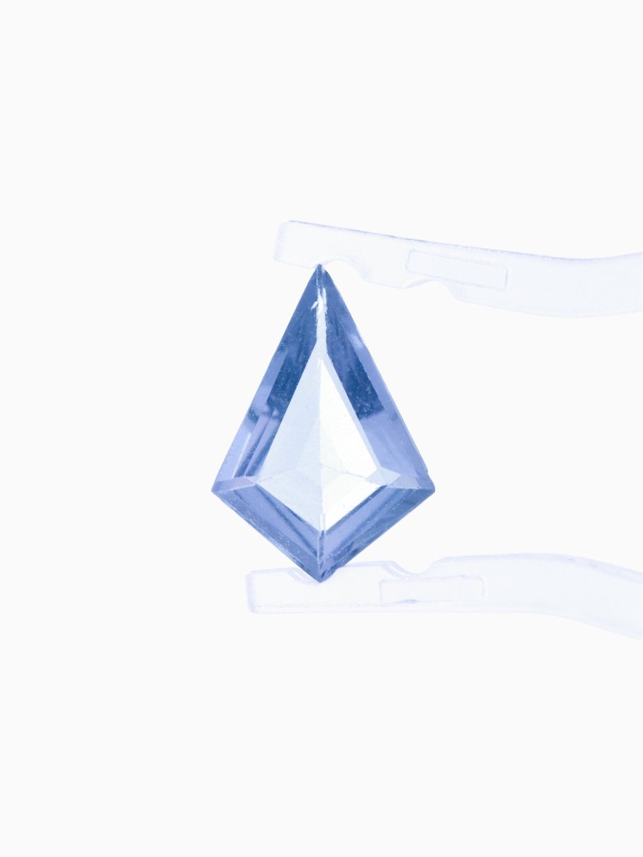 Faceted blue gemstone on a white background