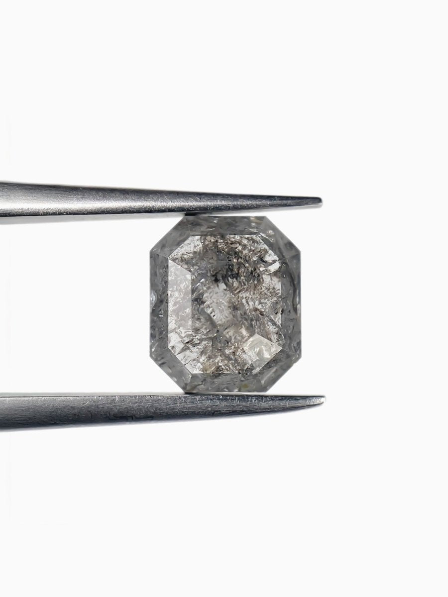 sustainable lab-grown emerald shaped salt pepper diamond between tweezers