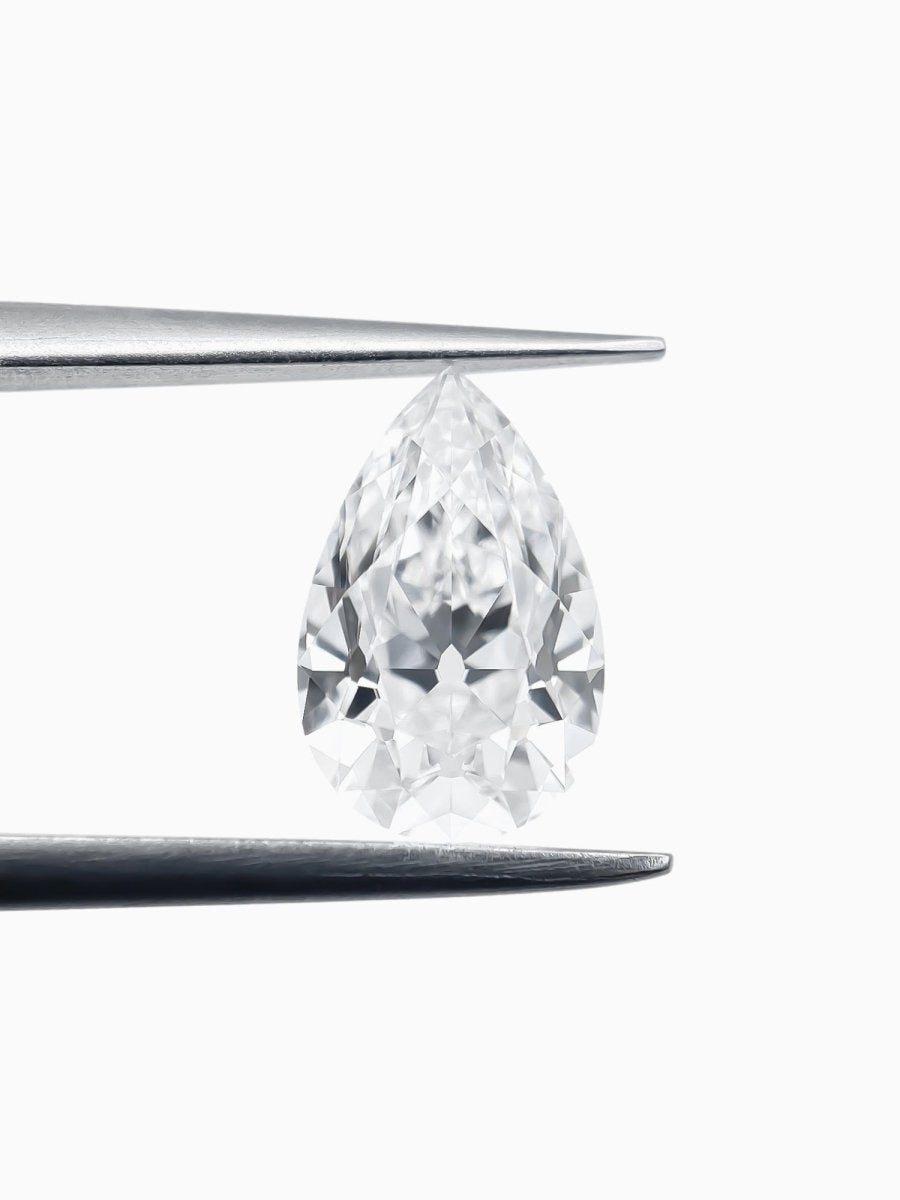 Pear-shaped diamond on a white background held by tweezers