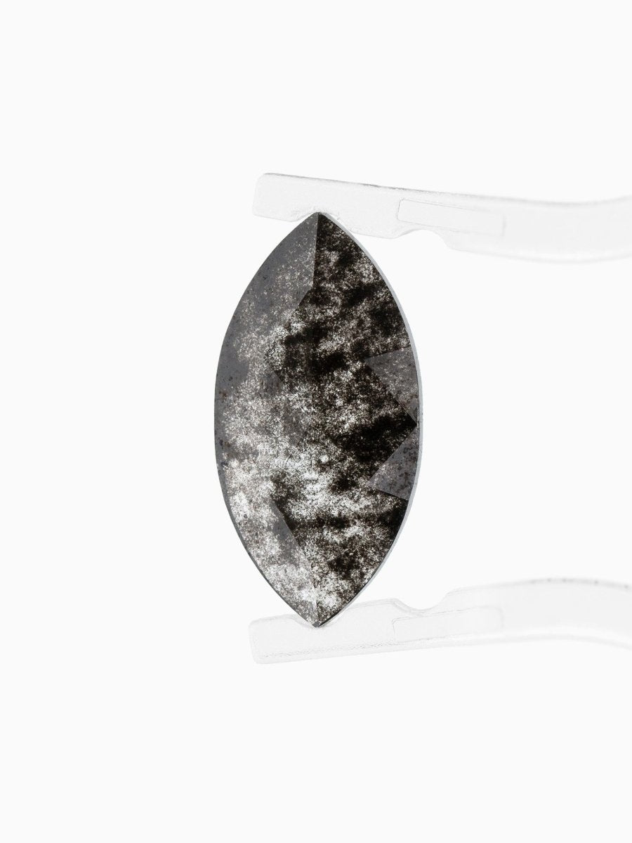 face view of loose lab-grown marquise salt pepper diamond gemstone held by tweezers
