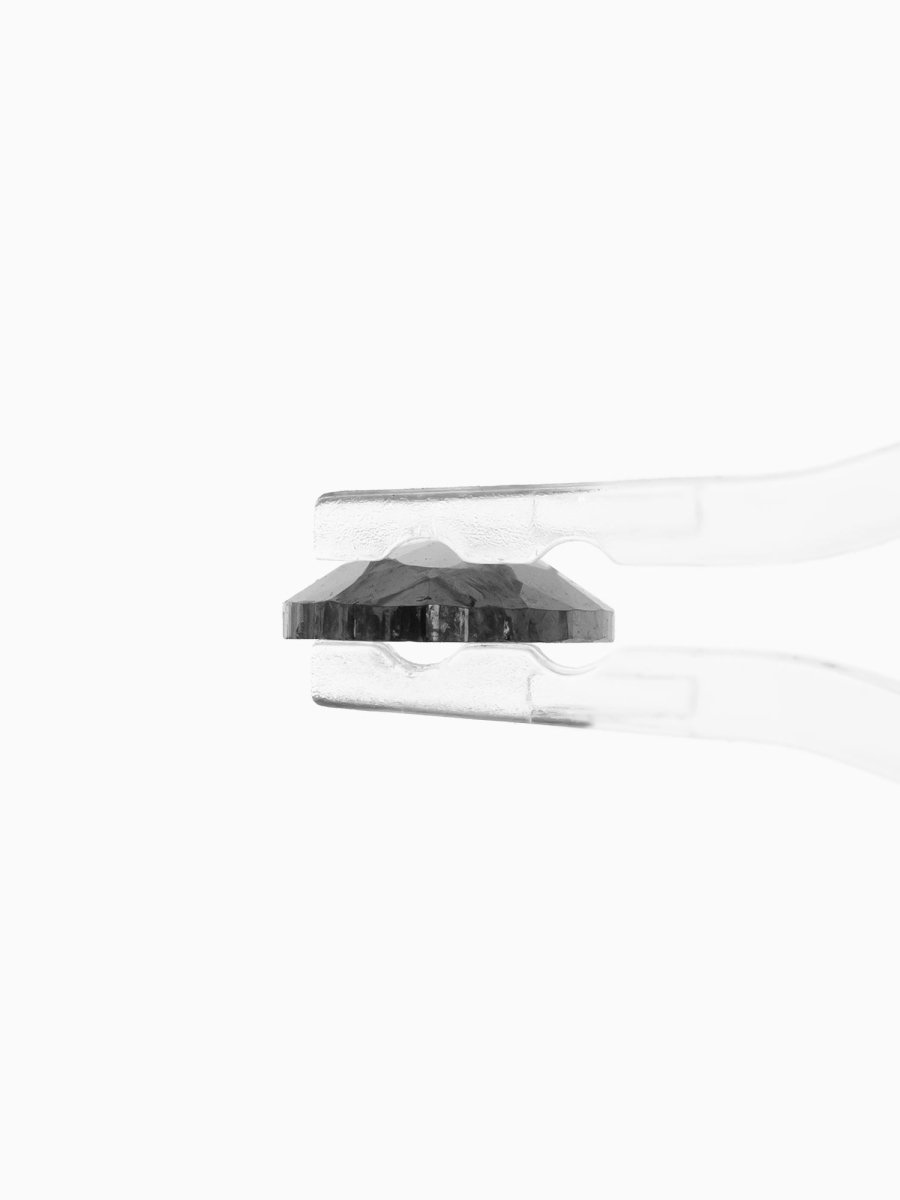 side view of loose lab-grown pear salt pepper diamond gemstone, held by tweezers