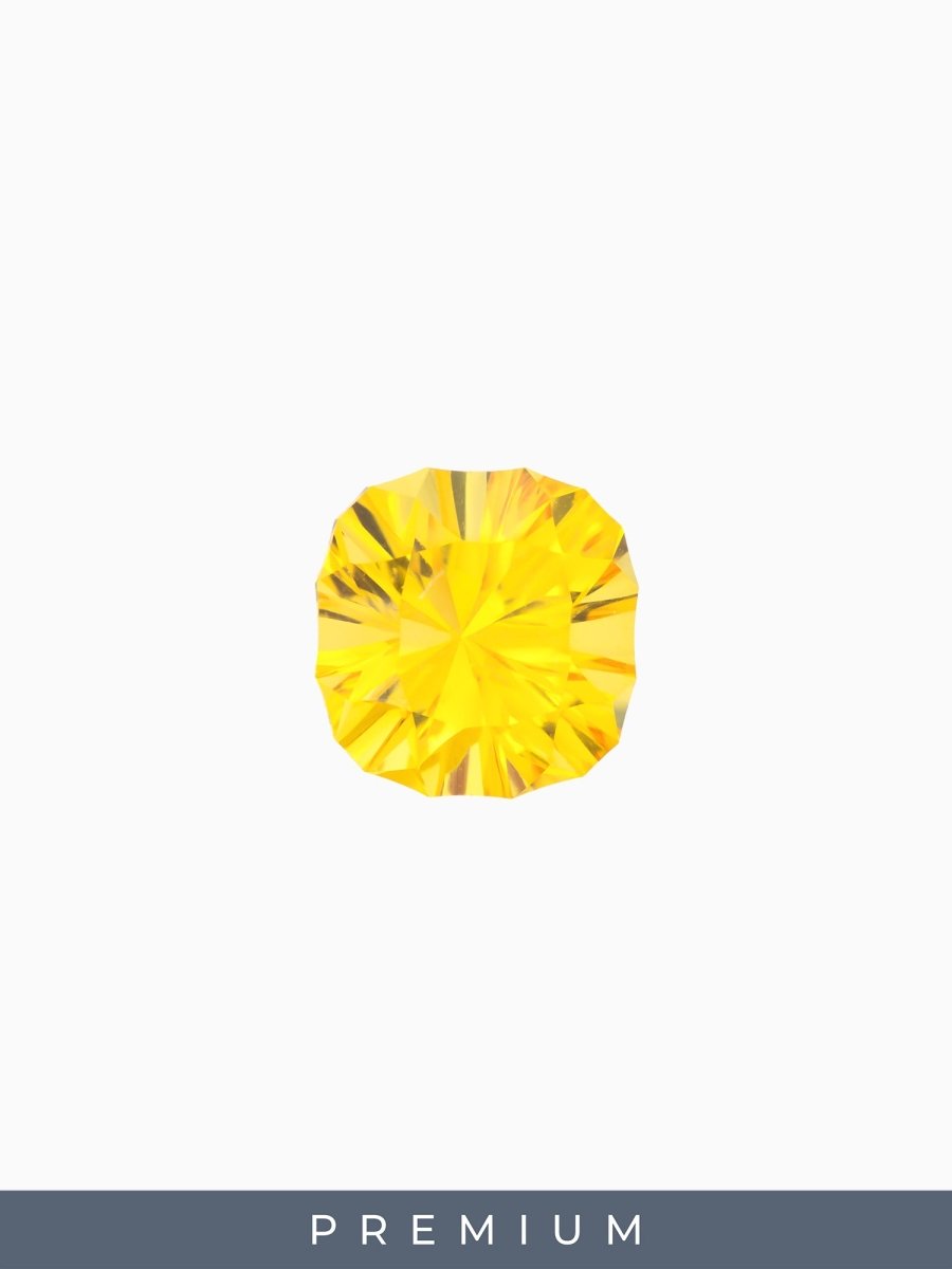face view of designer cut yellow cushion sapphire on a white background with premium label