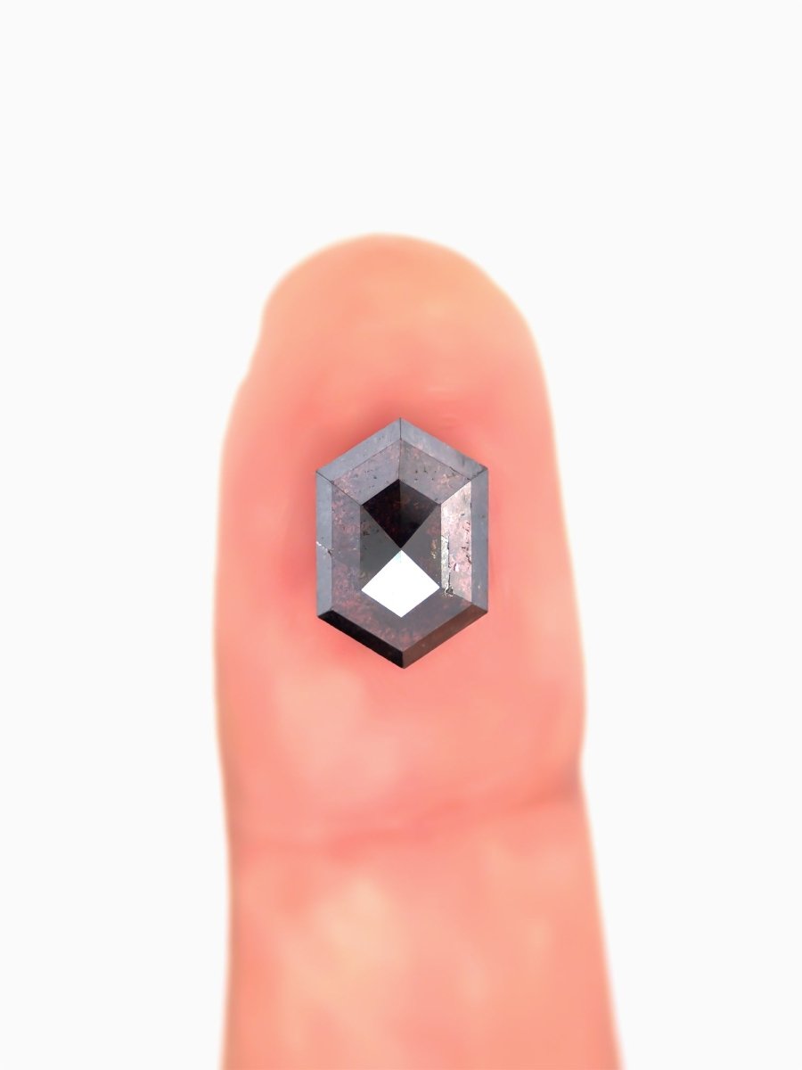 Small diamond on a finger for scale
