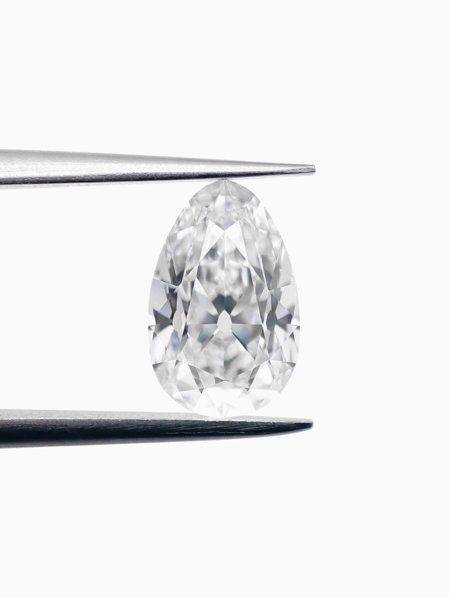 Pear-shaped diamond held by tweezers on a white background