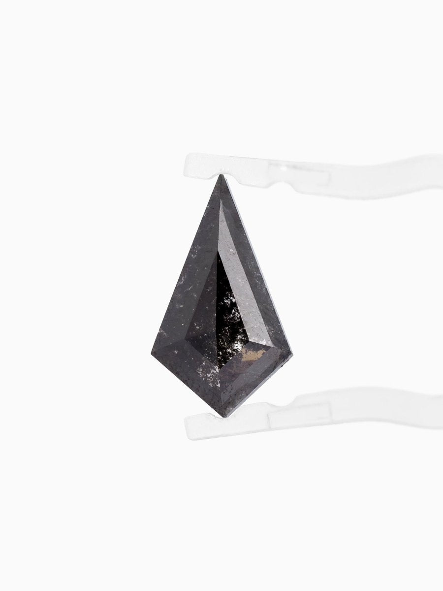 face view of loose lab-grown kite salt pepper diamond gemstone, held by tweezers