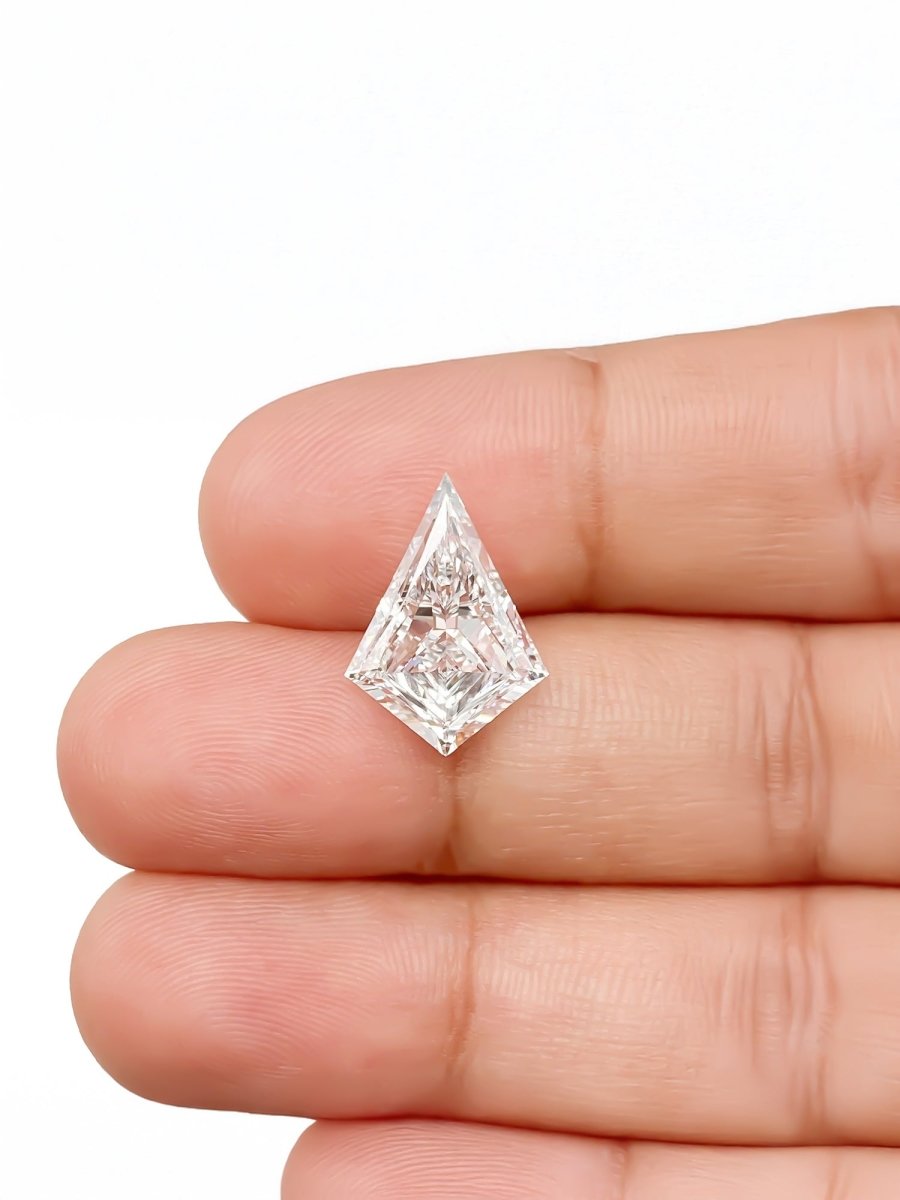 kite diamond held between fingers on a white background for scale