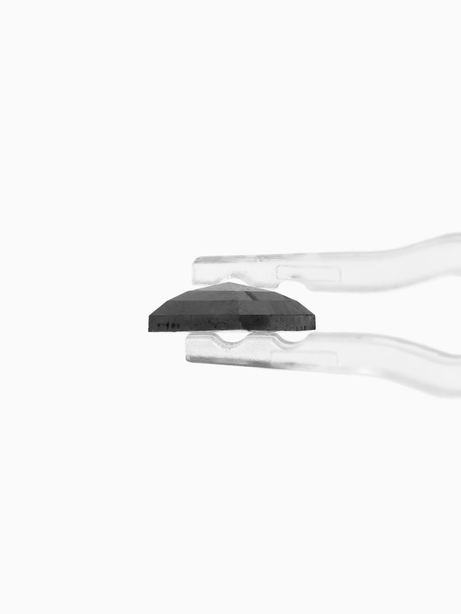 side view of loose lab-grown kite salt pepper diamond gemstone, held by tweezers