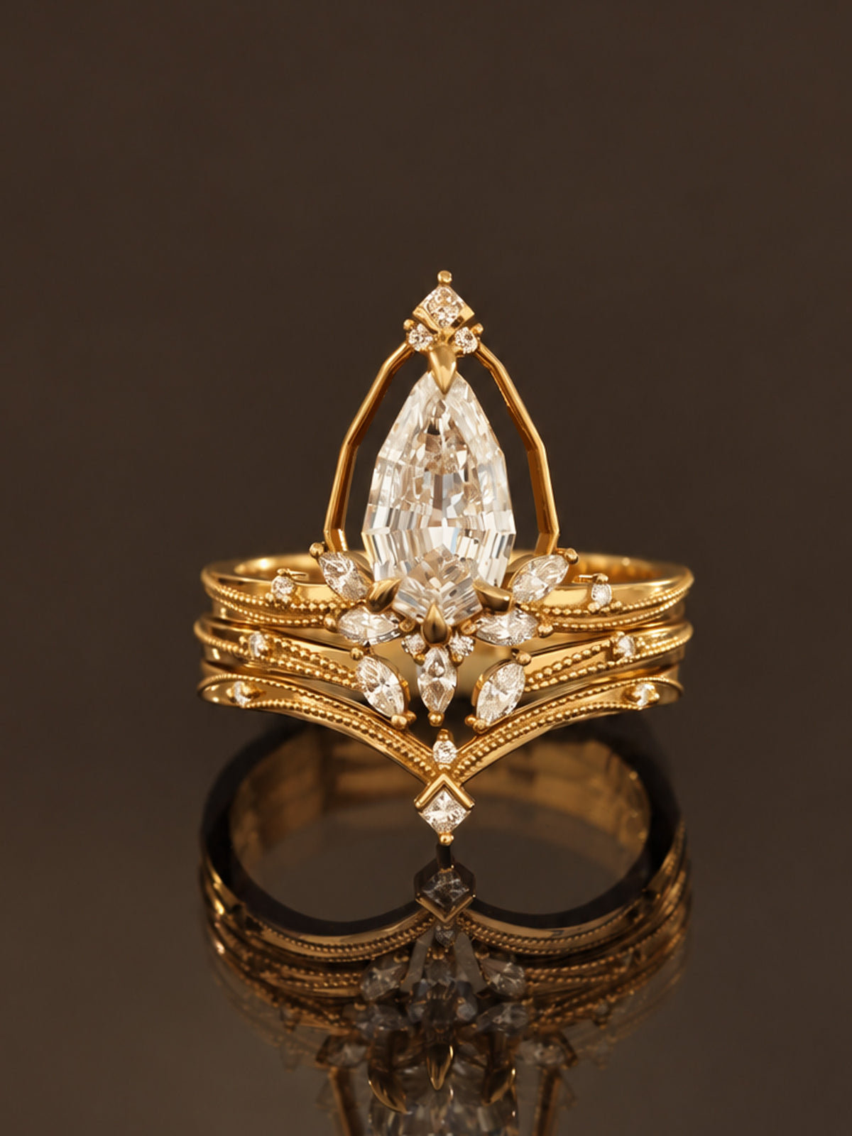 An ornate yellow gold ring featuring a large marquise-cut diamond center stone and smaller diamonds, displayed on a reflective dark surface against a dark brown background.