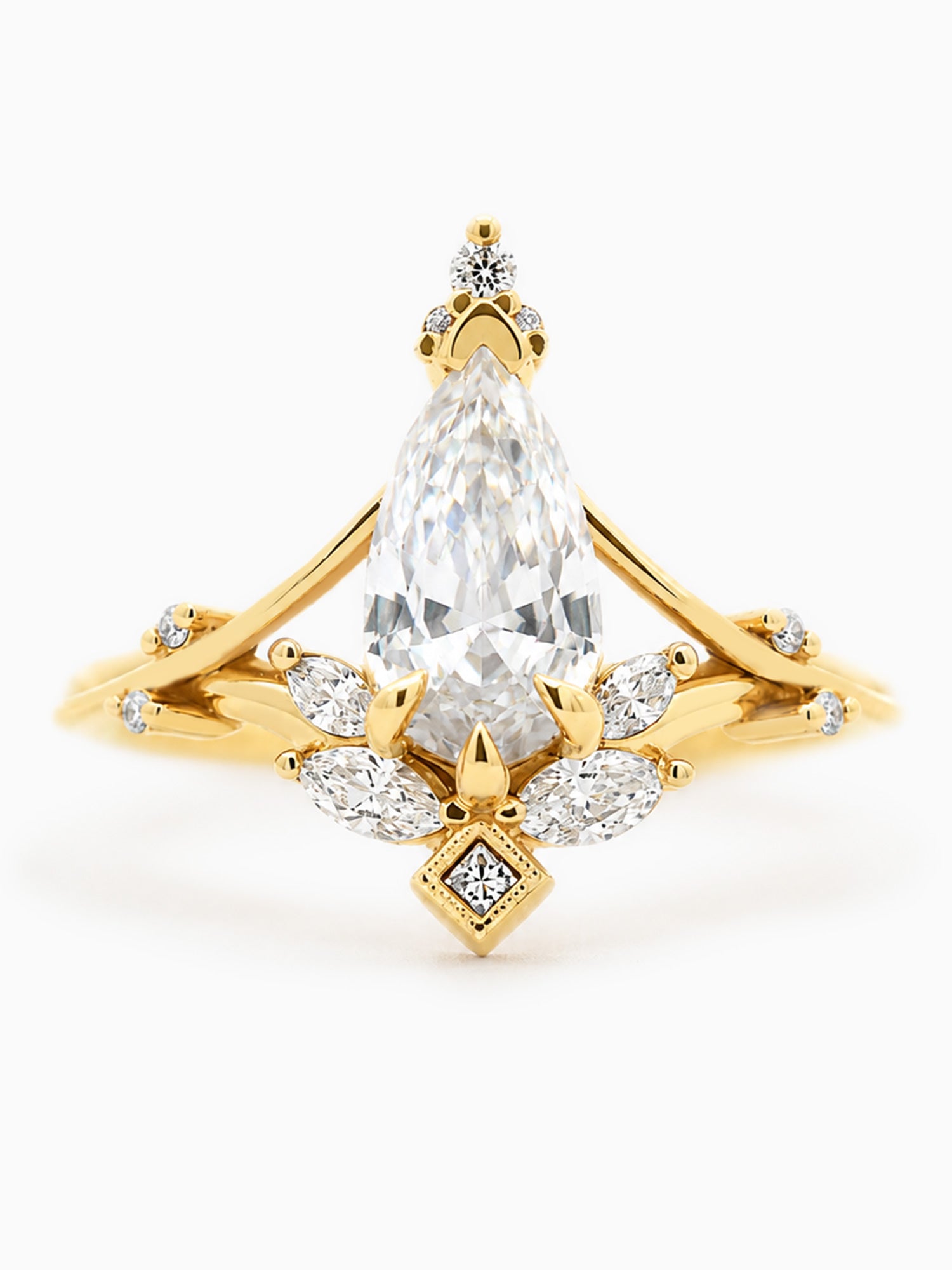 Gold ring with a pear-shaped diamond on a white background