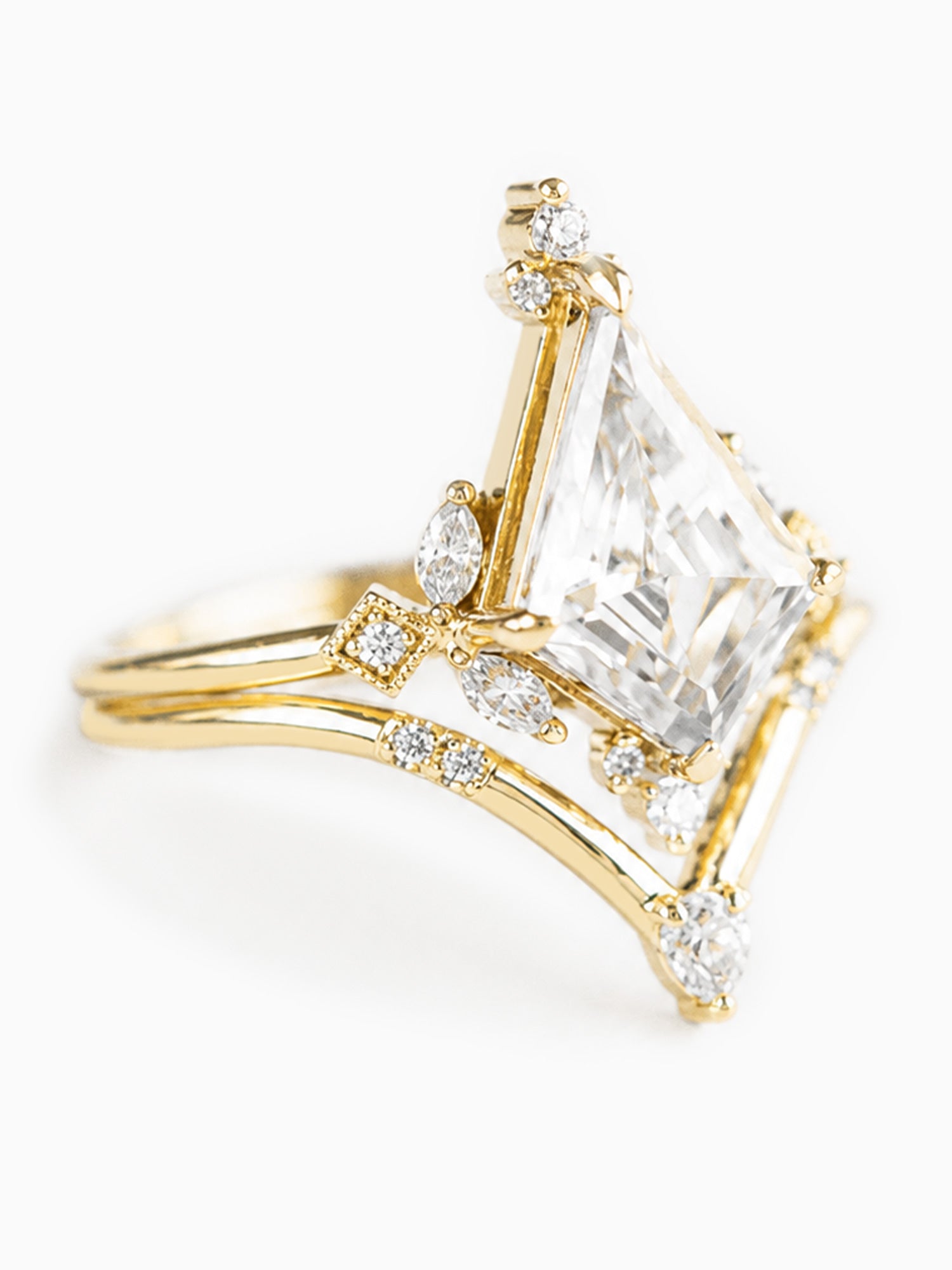 Gold ring with a large diamond on a white background