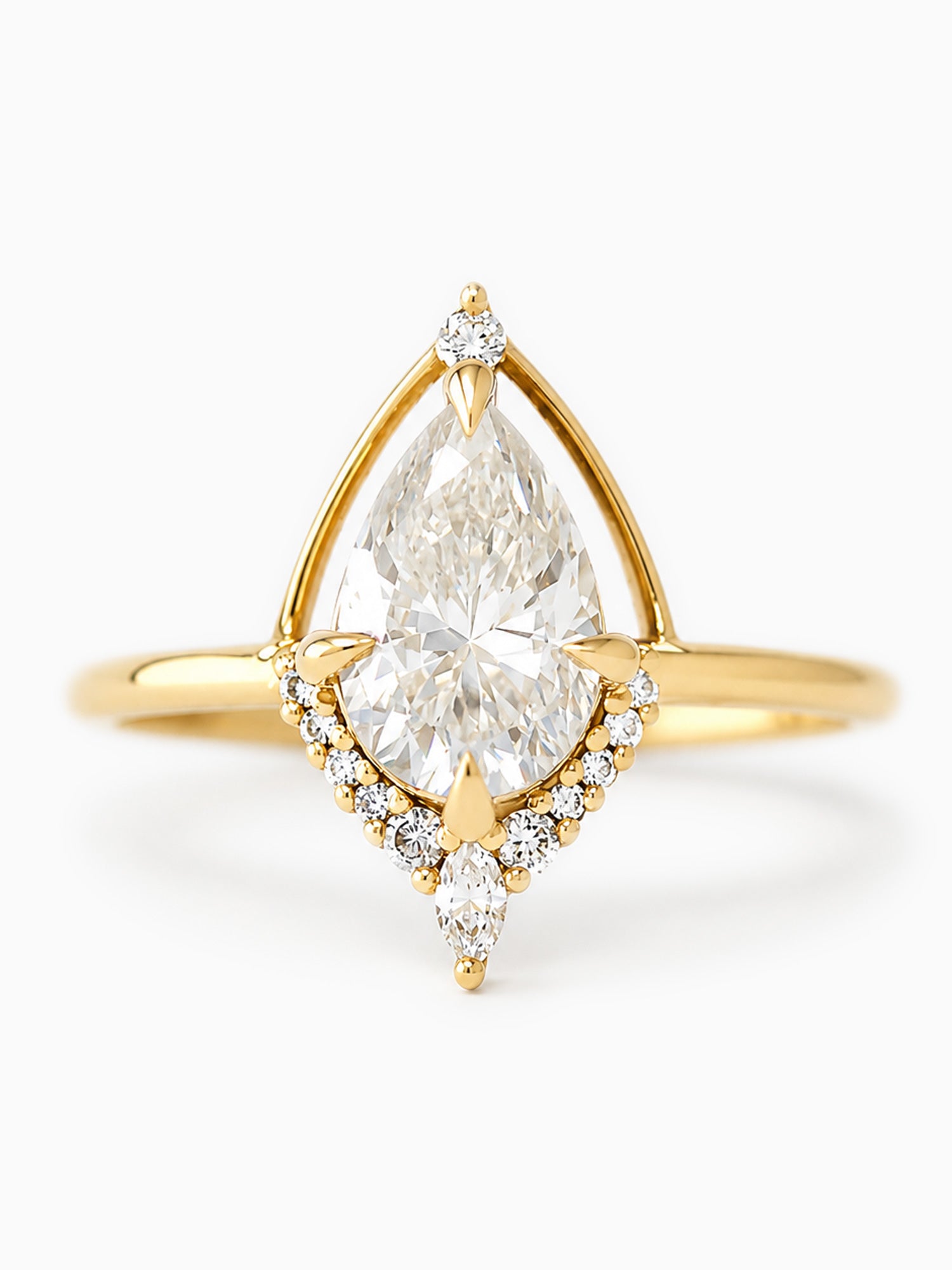 Gold ring with a pear-shaped diamond on a white background