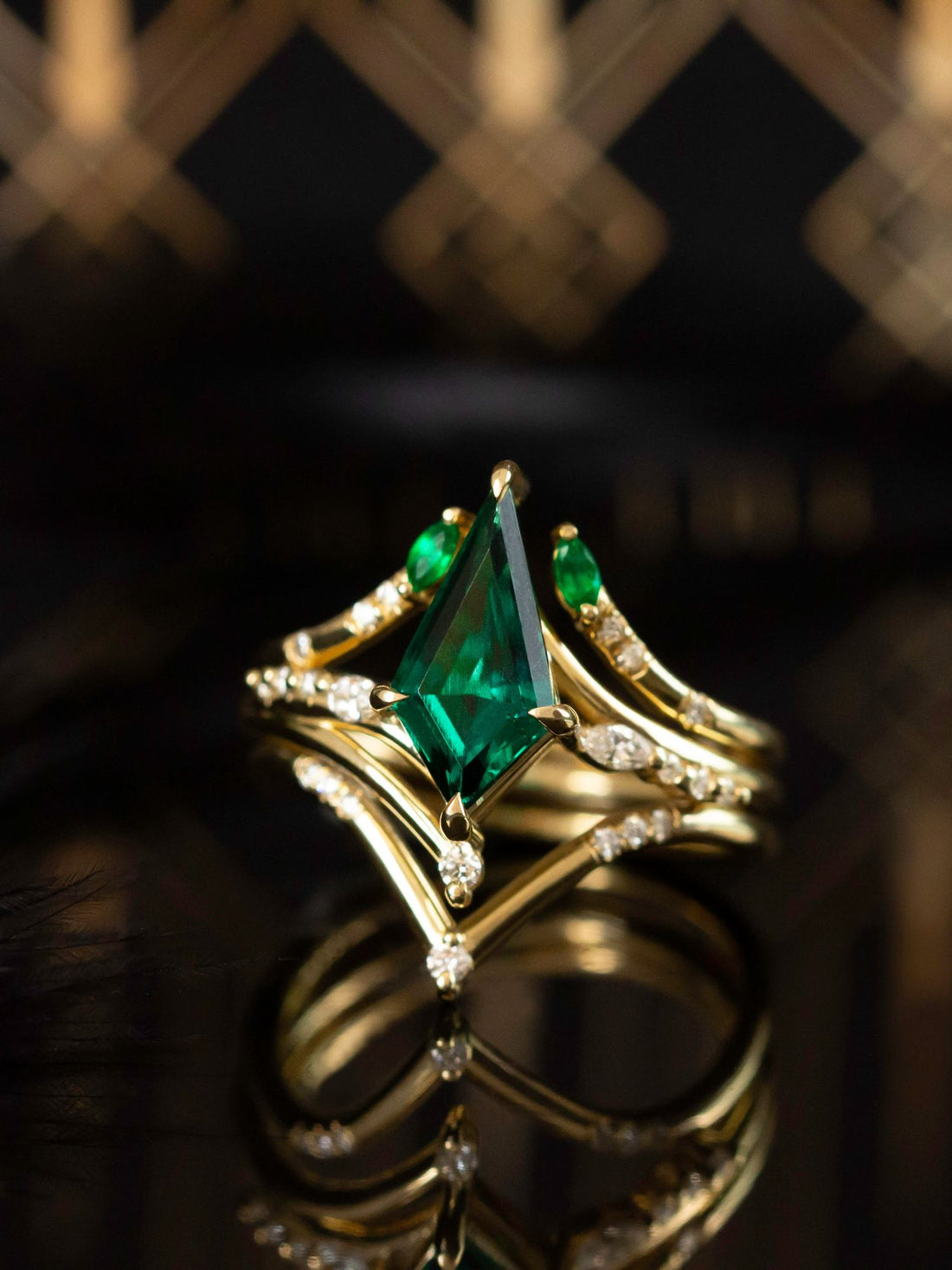 
Renee Ring HiddenSpace Emerald Kite 14k Yellow Gold Engagement Ring with Asymmetrical Slope Design Inspired by Art Deco Architecture Marquise Open Band Round Melee Diamonds