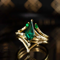 
Renee Ring HiddenSpace Emerald Kite 14k Yellow Gold Engagement Ring with Asymmetrical Slope Design Inspired by Art Deco Architecture Marquise Open Band Round Melee Diamonds