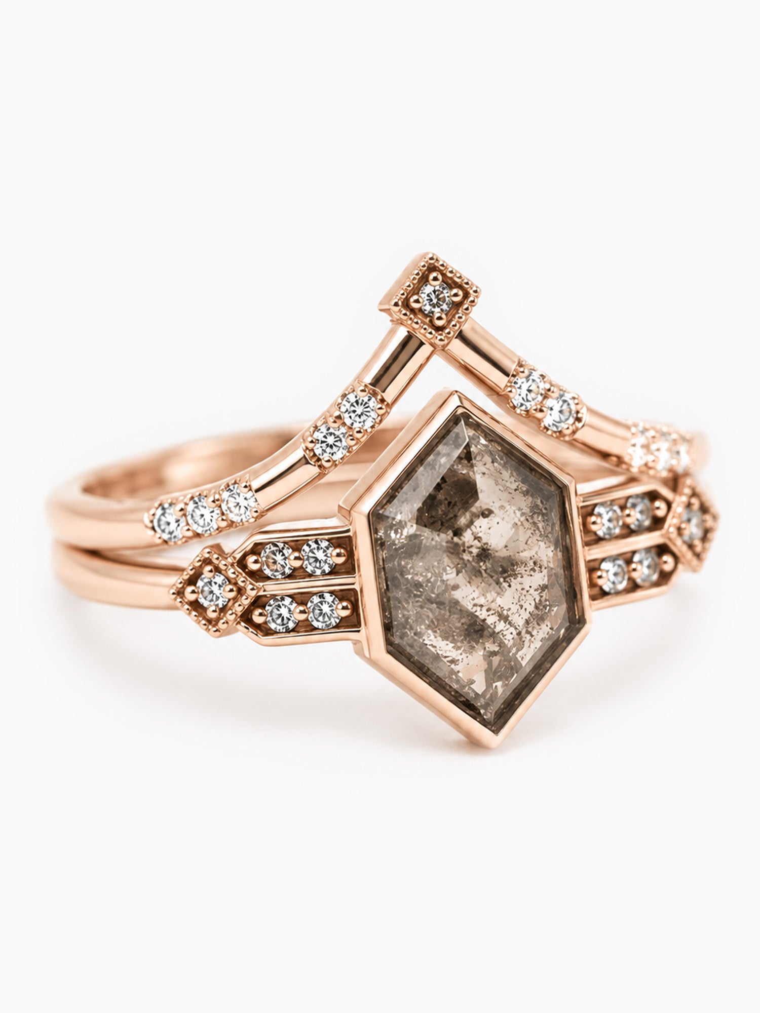 Rose gold ring with a large diamond and smaller diamonds on a white background