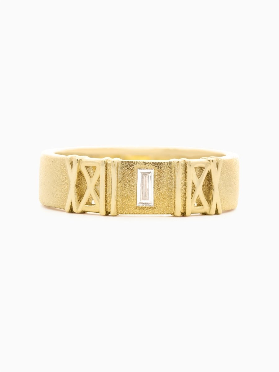 Matte gold band with see-through baguette diamond set between bold architectural lines.