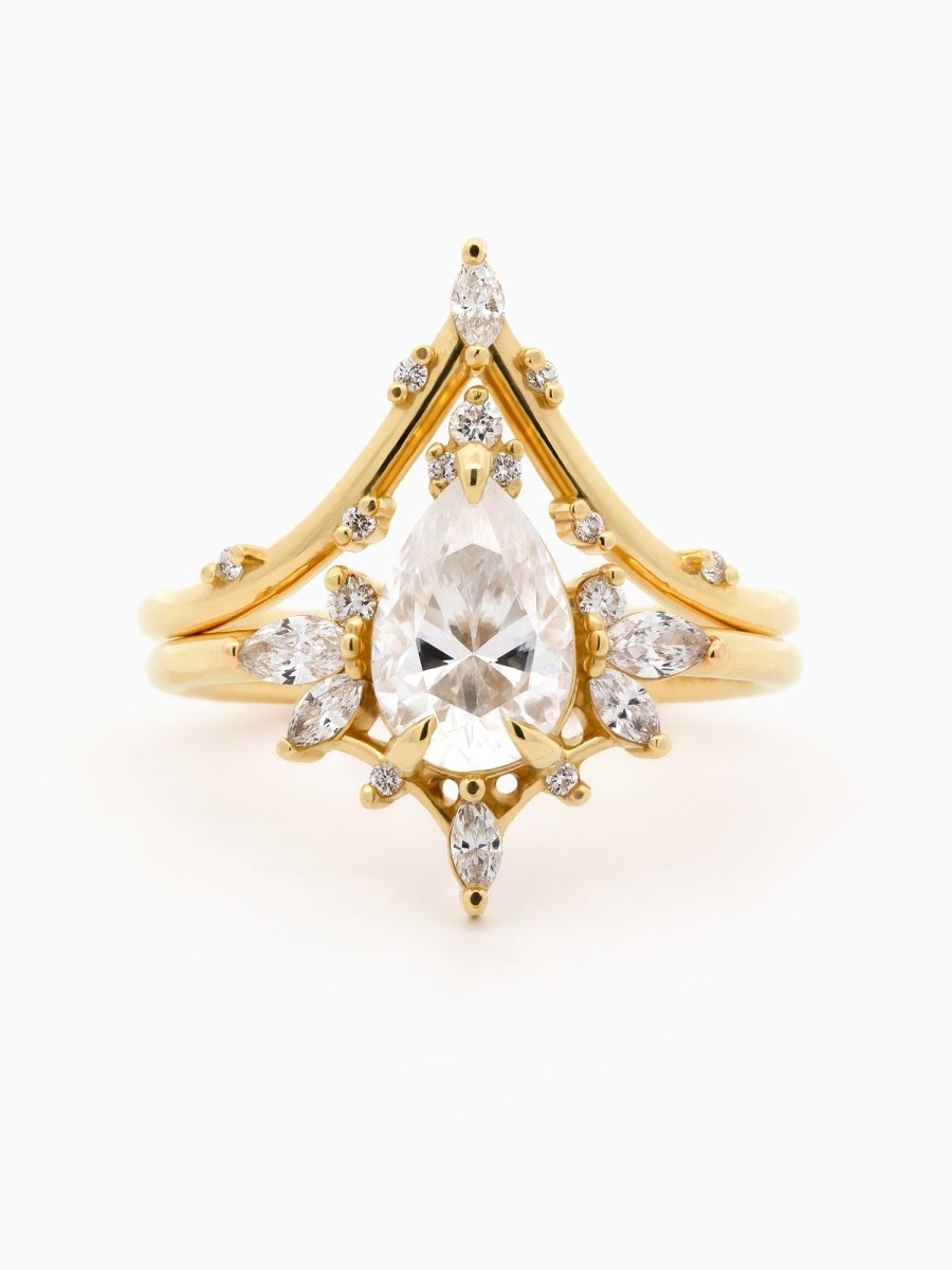 Gold ring with a central diamond and smaller diamonds on a white background