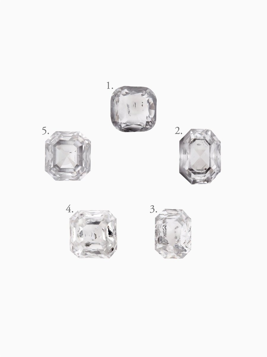 Five diamonds of different shapes and sizes on a white background