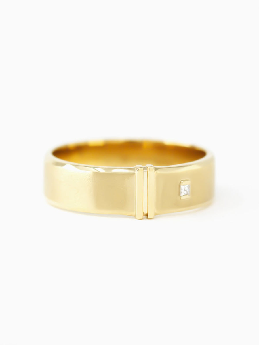 Gold ring with a small diamond on a white background