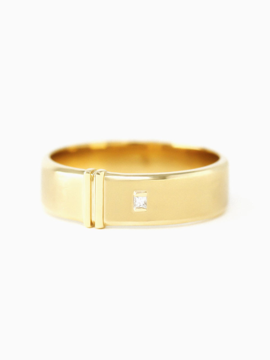 Gold ring with a small diamond on a white background