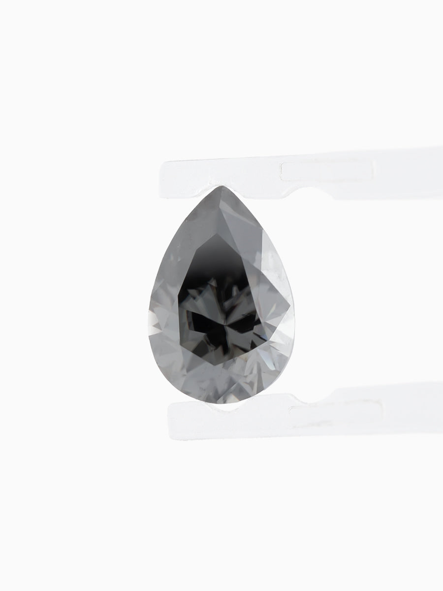 Black Pear Shaped Moissanite on White Background Held by tweezers, Face view