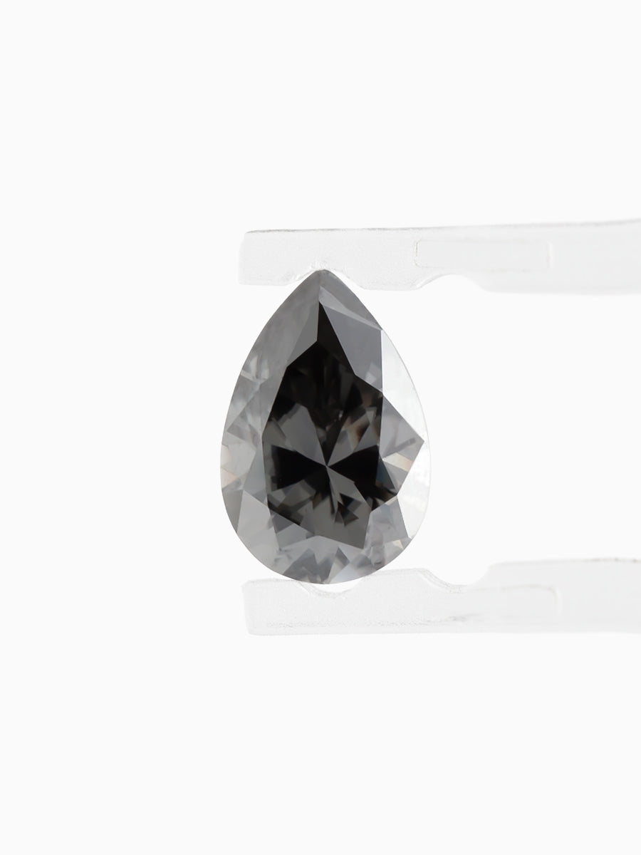 Black Pear Shaped Moissanite on White Background Held by tweezers, Face view