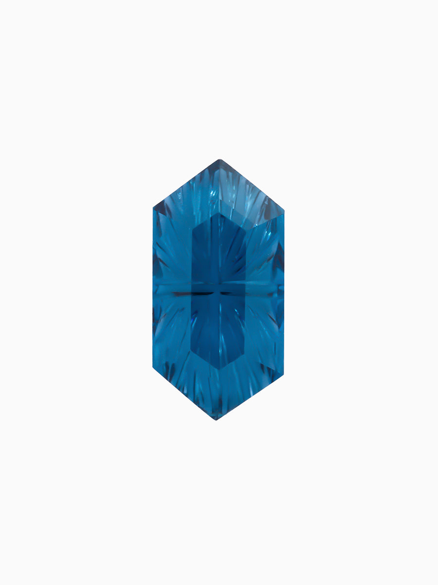 lab grown fantasy cut deep blue topaz hexagon with radiating facets on white background