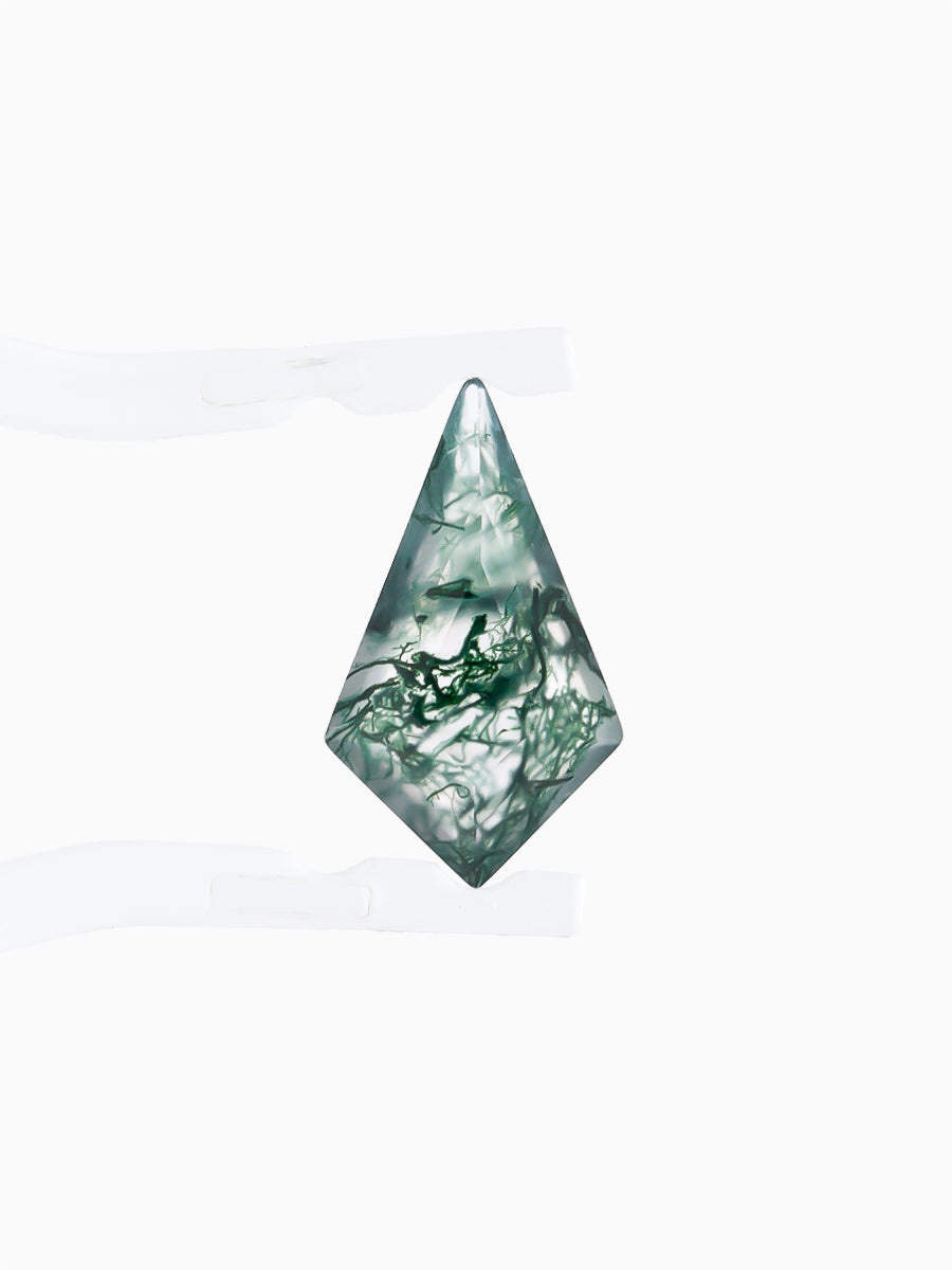 Kite-shaped loose moss agate gemstone with dendritic green inclusions held by tweezers, face view